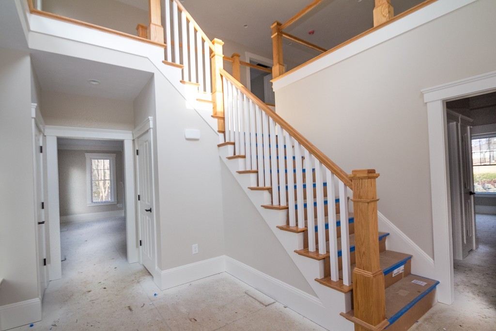 27 Birch Road Littleton, MA 01460 - Photo 7 of 22 a view of staircase with lots of frames on wall and wooden floor