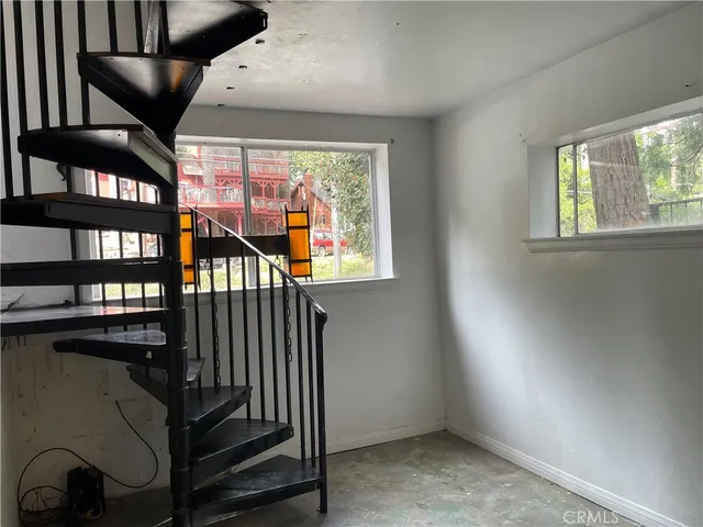an empty room with windows and closet