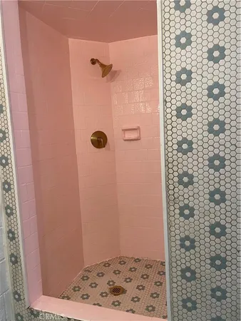 a bathroom with a sink and mirror with bathtub