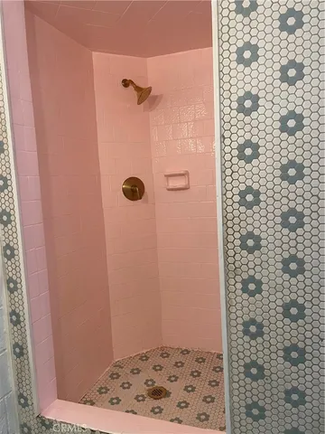 a bathroom with a sink and mirror with bathtub