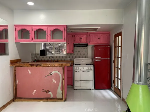 a kitchen with stainless steel appliances granite countertop a stove top oven