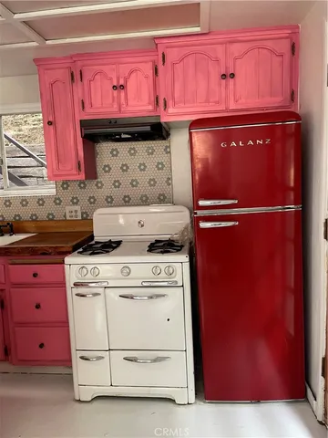 a kitchen with stainless steel appliances granite countertop a stove and a microwave