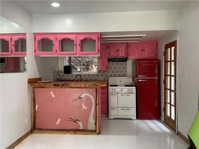 a kitchen with stainless steel appliances granite countertop a refrigerator and a stove top oven