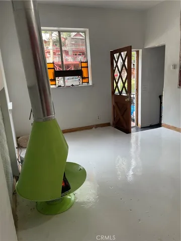 a view of a livingroom with wooden floor and windows