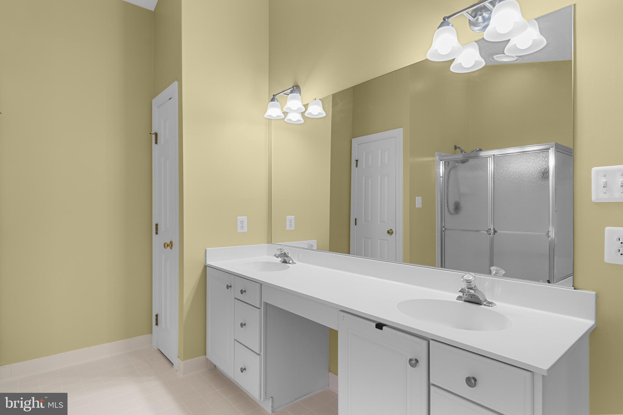 4615 Brightwood Road Olney, MD 20832 - Photo 22 of 45 a bathroom with a double vanity sink and a mirror