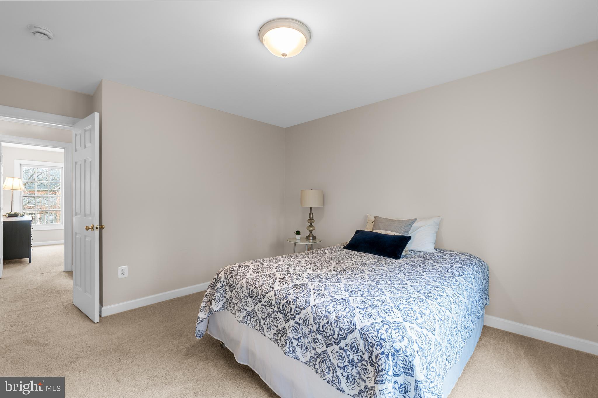 4615 Brightwood Road Olney, MD 20832 - Photo 28 of 45 a bedroom with a large bed and a chandelier