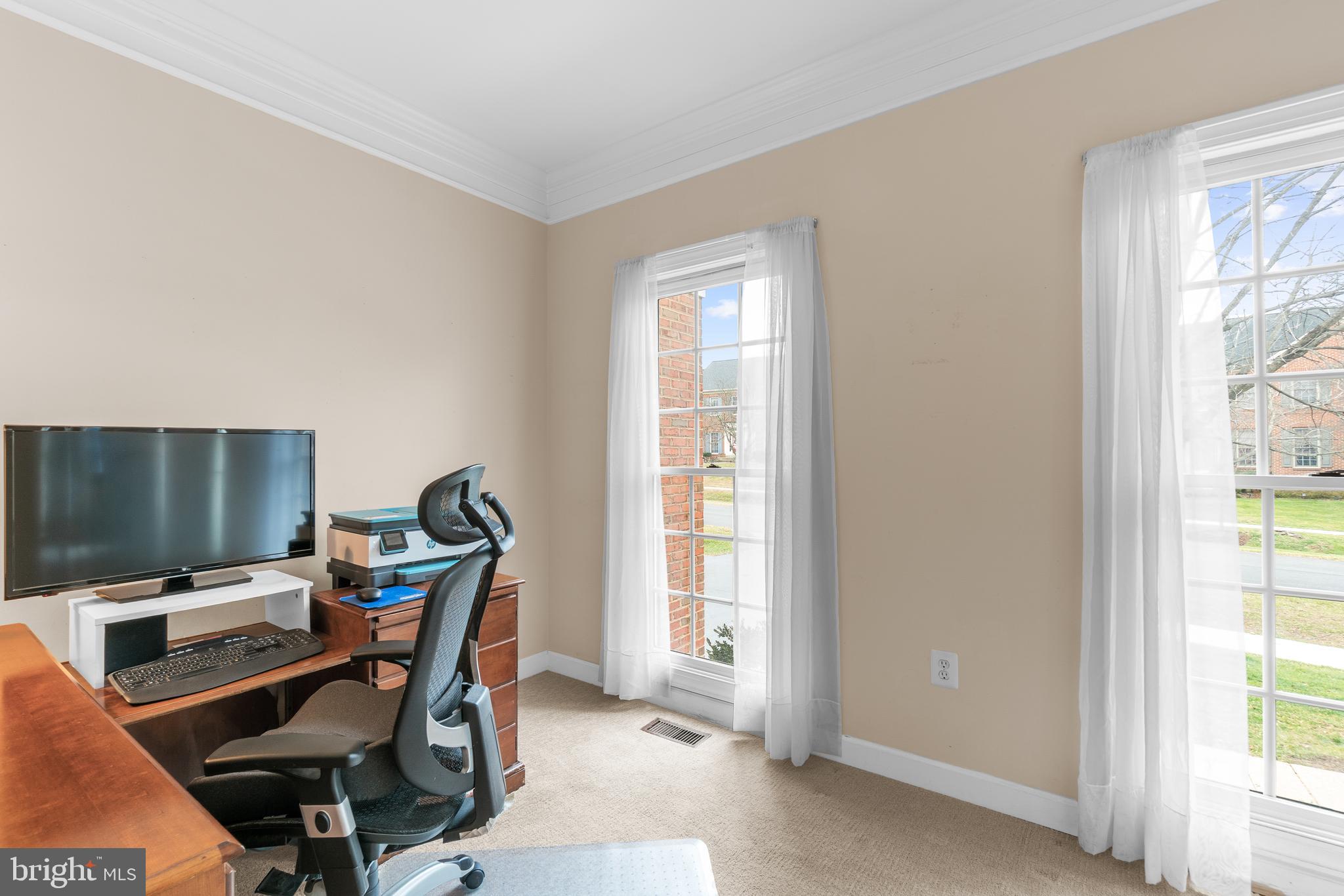 4615 Brightwood Road Olney, MD 20832 - Photo 3 of 45 a view of a workspace with furniture and a window