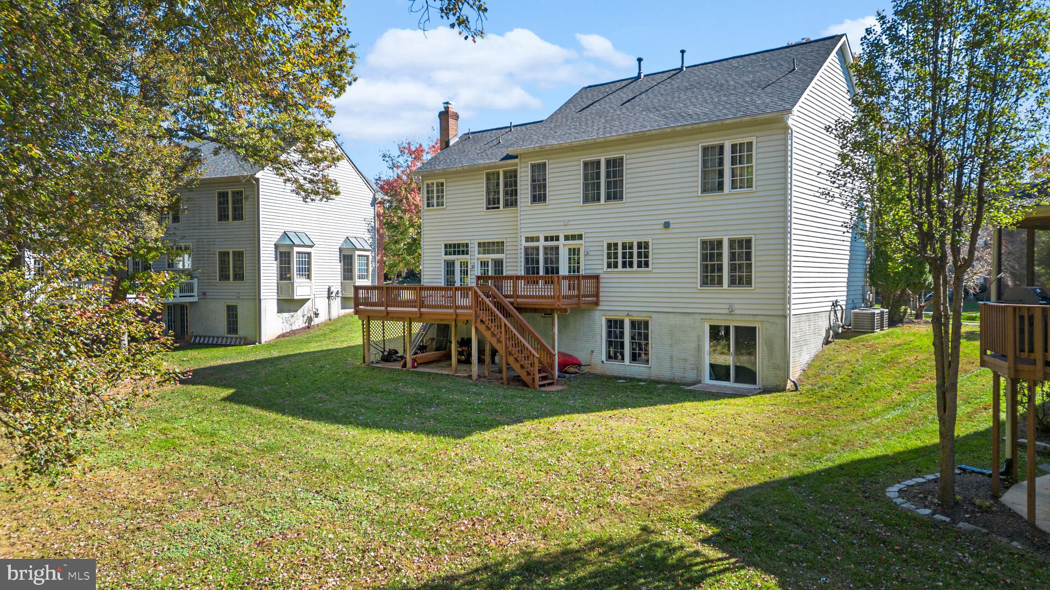 4615 Brightwood Road Olney, MD 20832 - Photo 42 of 45 a view of a house with a yard deck and a large tree