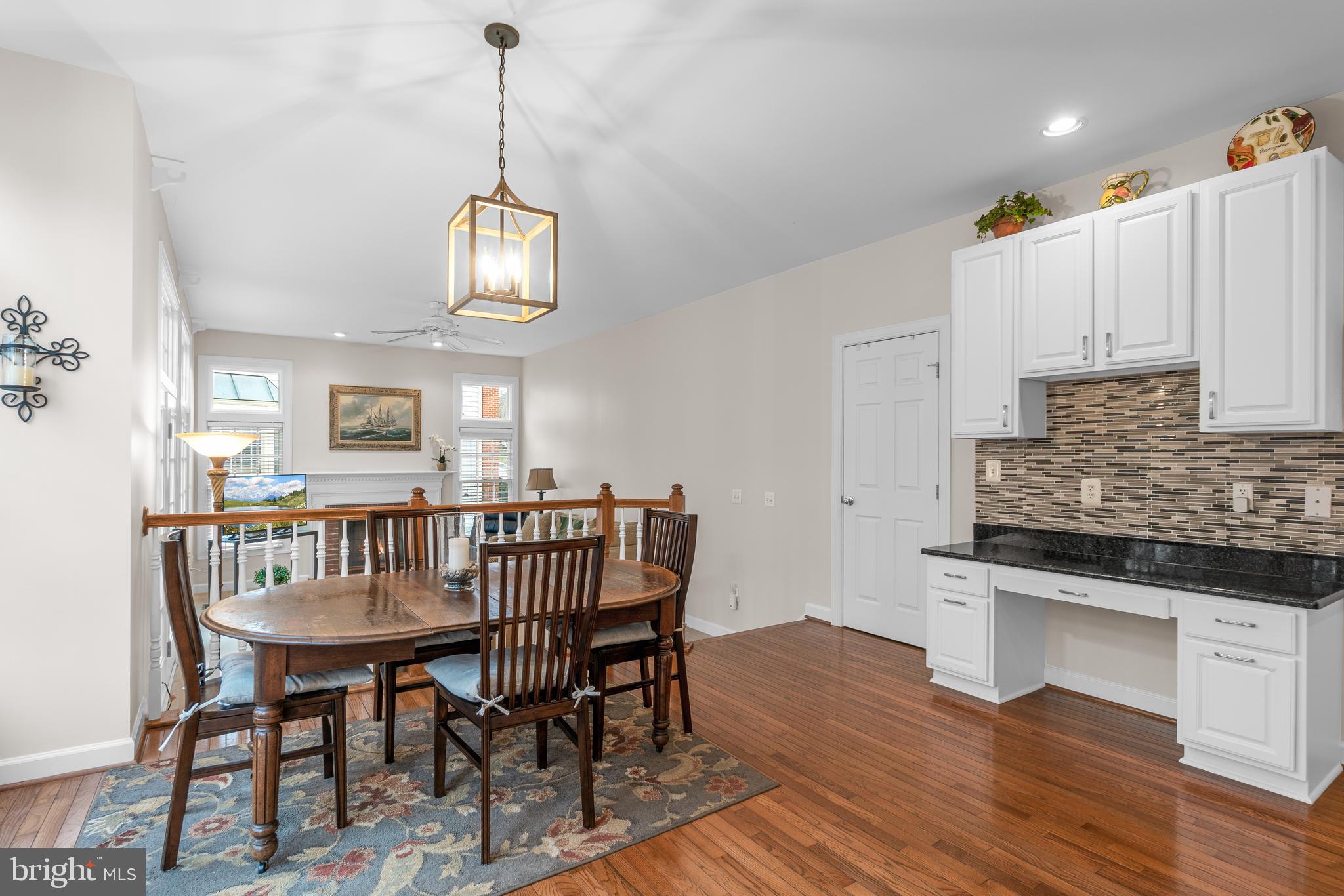 4615 Brightwood Road Olney, MD 20832 - Photo 10 of 45 a view of dining room and kitchen with furniture wooden floor and a chandelier