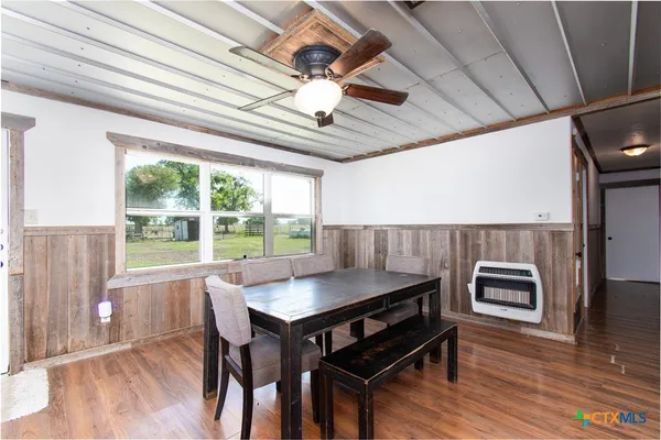 a dining room with furniture window and wooden floor