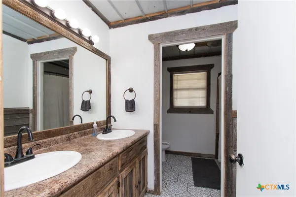 a view of hallway with closet and chandelier fan