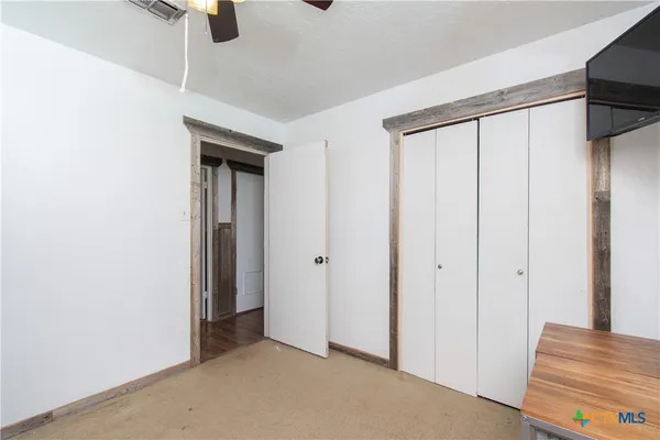 a bed room with a bed and a ceiling fan