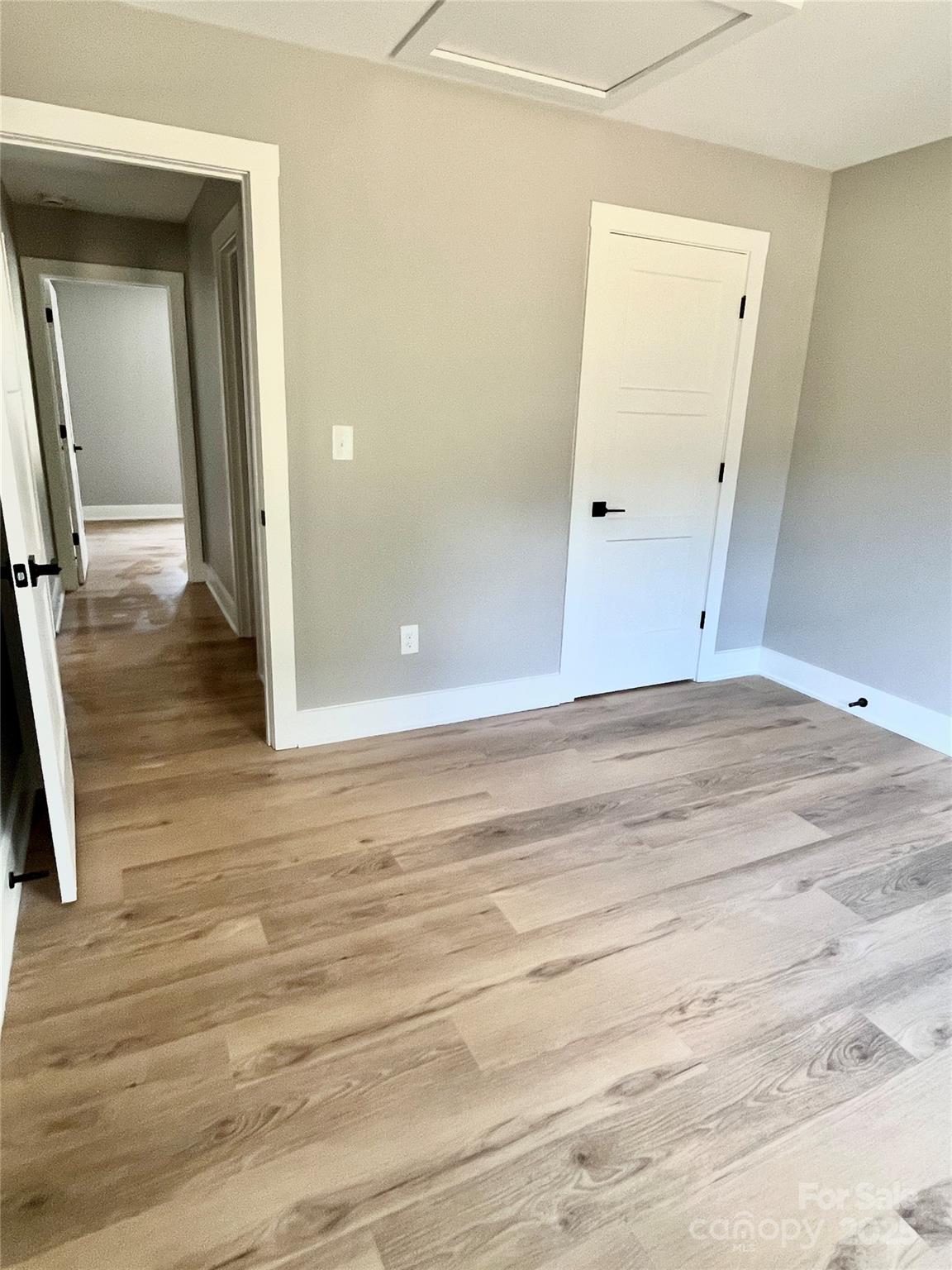 6255 Old Salisbury Road Linwood, NC 27299 - Photo 13 of 21 a view of a room with wooden floor and white doors