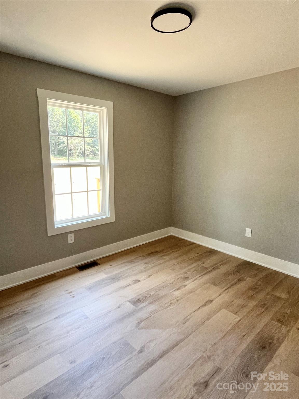 6255 Old Salisbury Road Linwood, NC 27299 - Photo 14 of 21 a view of empty room with wooden floor and fan