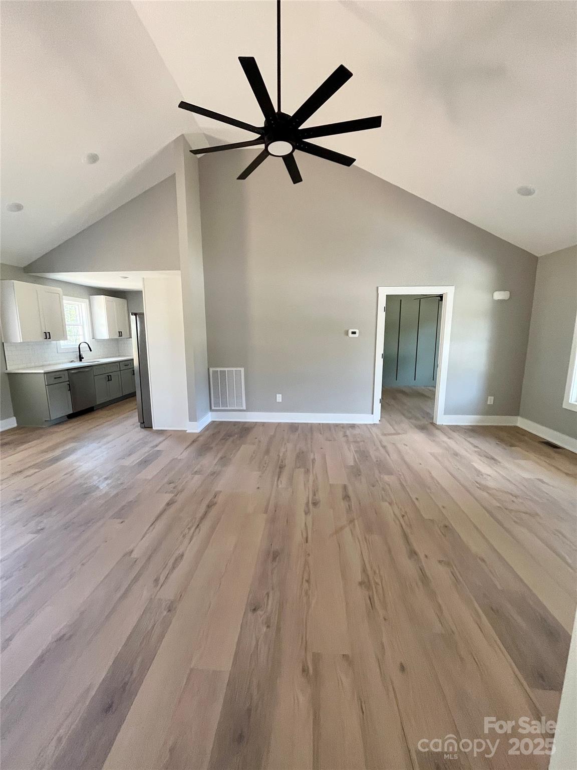 6255 Old Salisbury Road Linwood, NC 27299 - Photo 3 of 21 a view of a livingroom with a ceiling fan and wooden floor