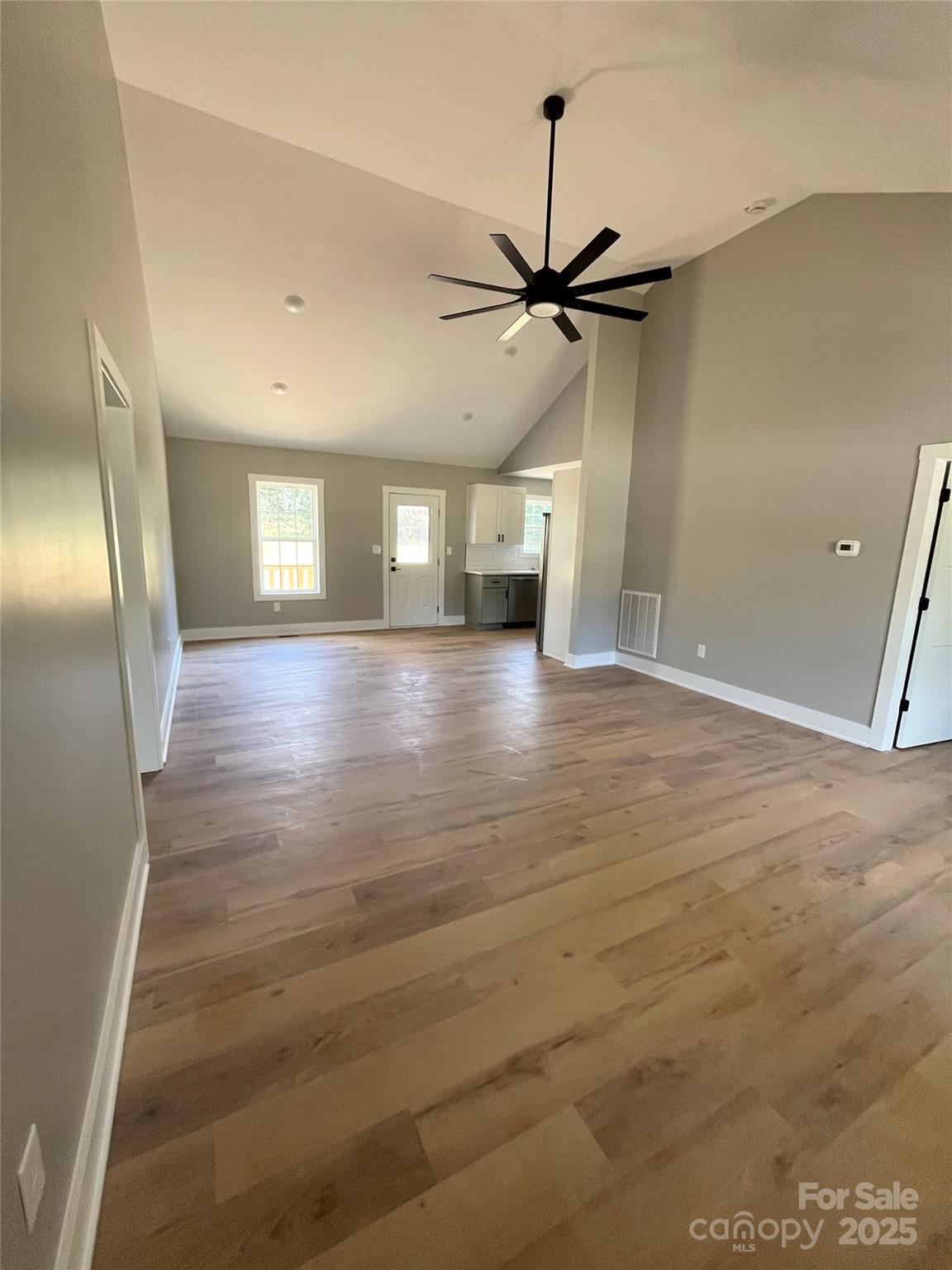 6255 Old Salisbury Road Linwood, NC 27299 - Photo 6 of 21 an empty room with wooden floor and windows