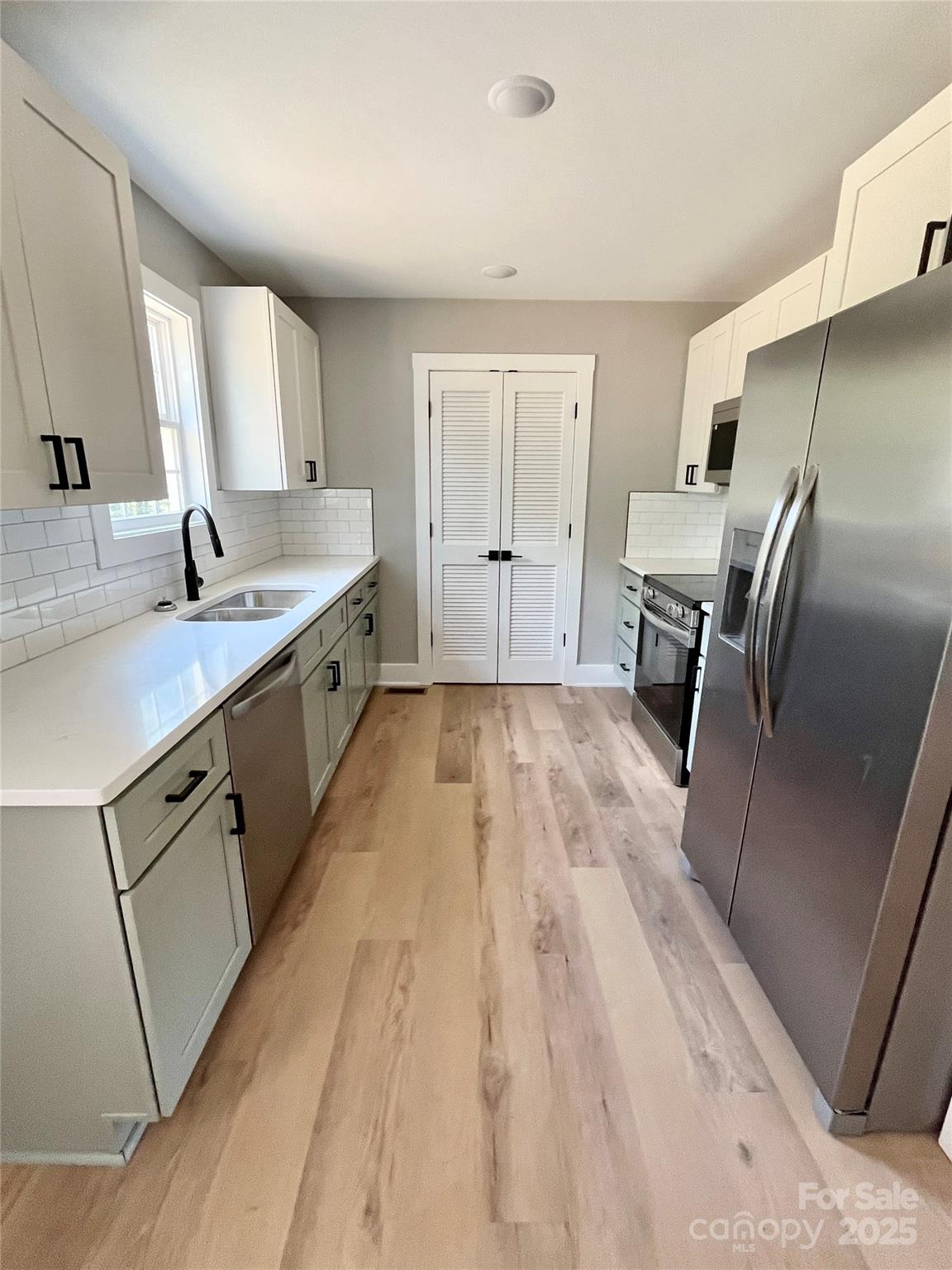 6255 Old Salisbury Road Linwood, NC 27299 - Photo 7 of 21 a large kitchen with a sink and refrigerator