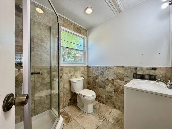 a bathroom with a toilet sink and a shower