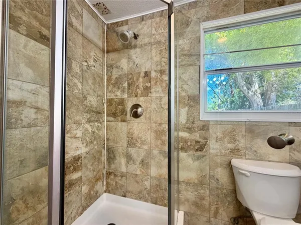 a bathroom with a shower and a toilet