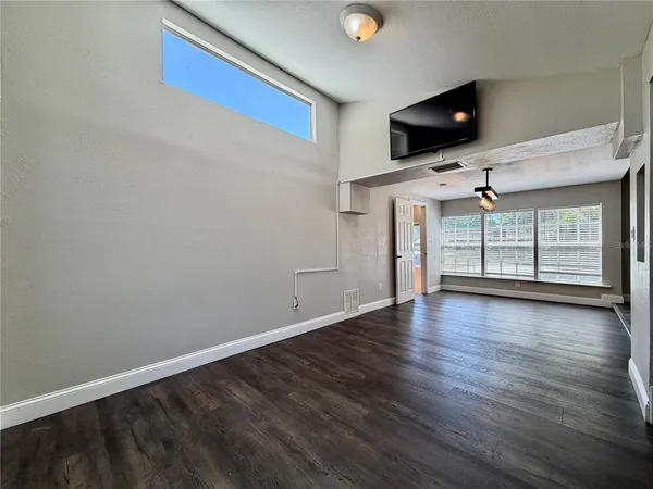 a view of a livingroom with furniture and a flat screen tv