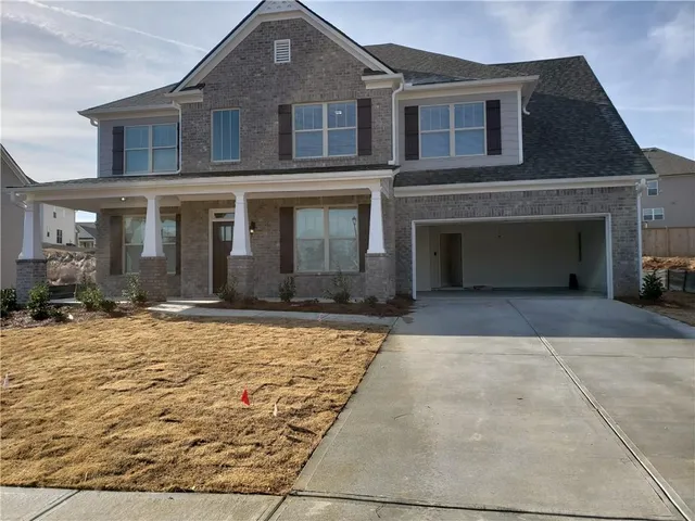 a front view of a house with yard