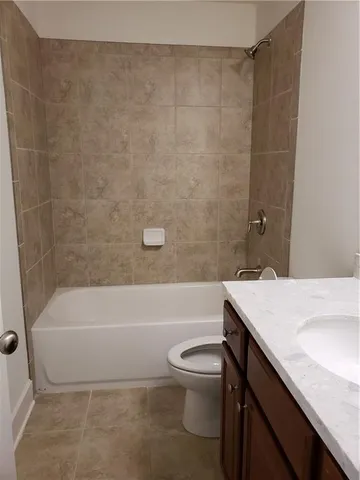 a bathroom with a sink a toilet and a bathtub