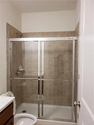 a bathroom with a shower and a sink