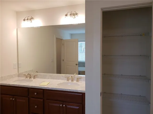 a bathroom with a double vanity sink and a mirror