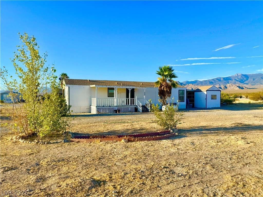 6471 Hafen Ranch Road Pahrump, NV 89061 - Photo 20 of 22 A desert oasis with a cozy manufactured home, offering vast outdoor space and mountain vistas.