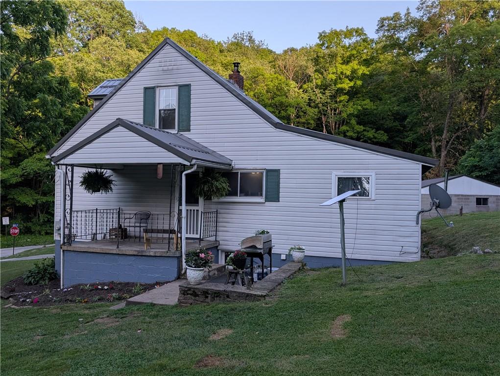 205 Woods Road Ligonier, PA 15658 - Photo 21 of 32 a front view of a house with a garden and yard