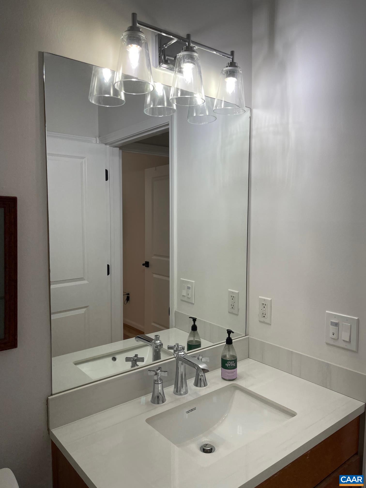 710 Walker Square, Unit 2B Charlottesville, VA 22903 - Photo 9 of 11 a bathroom with a sink and a mirror