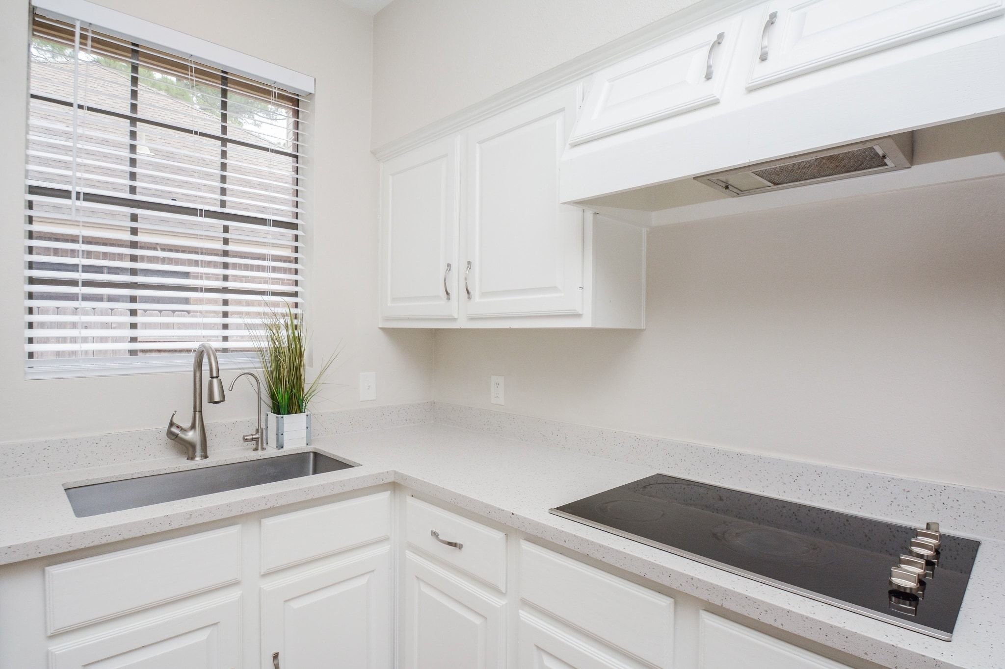 10 Heathstone Place The Woodlands, TX 77381 - Photo 9 of 27 Electric stovetop, window provides natural light, enhancing the clean, fresh look.
