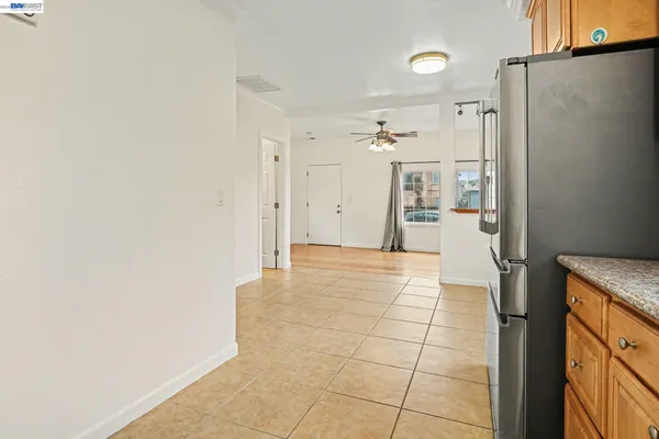 a view of a refrigerator in kitchen and a window