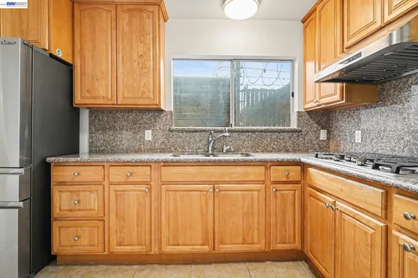 a kitchen with stainless steel appliances granite countertop a refrigerator and sink