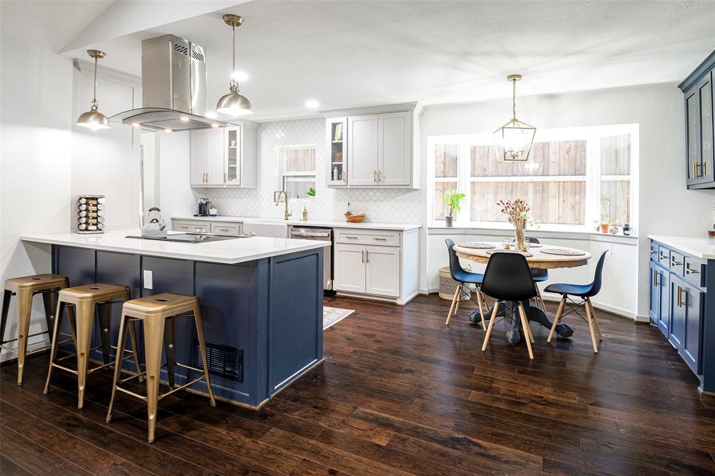 a view of a dining room and livingroom with furniture wooden floor a chandelier