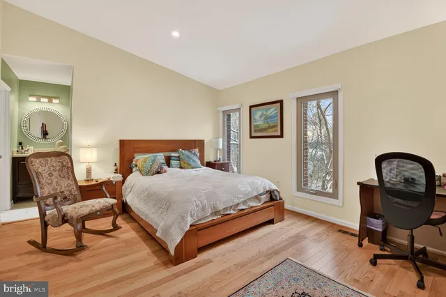 a bedroom with a bed a desk and chair