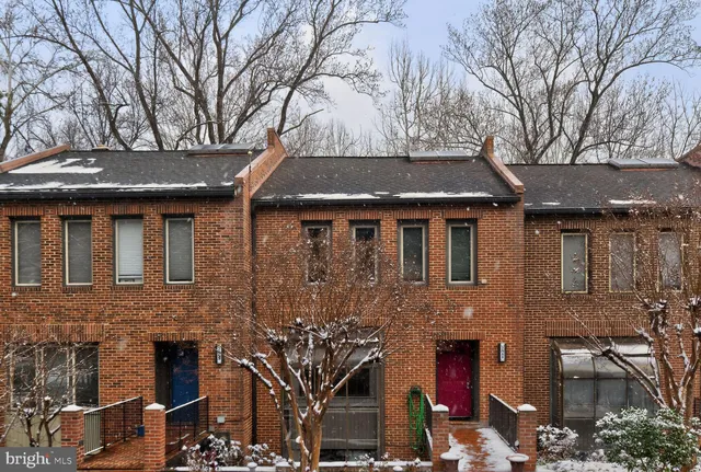 a front view of a house with a tree
