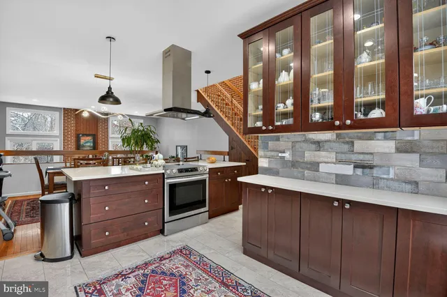 a kitchen with a sink stove and cabinets
