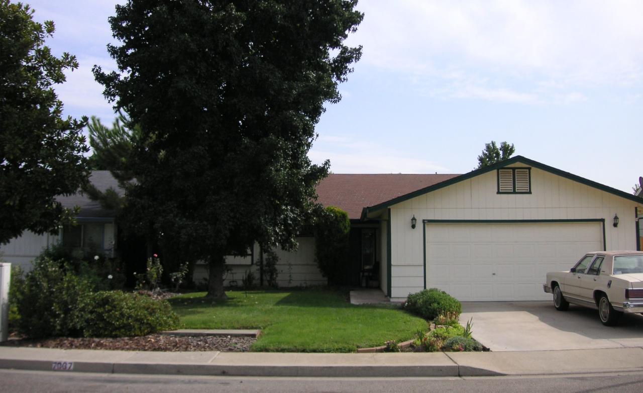 7067 Pit Road Redding, CA 96001 - Photo 1 of 11 a car parked in front of a house with a yard
