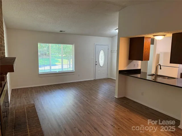 a living room with hard wood floors and a wooden floors