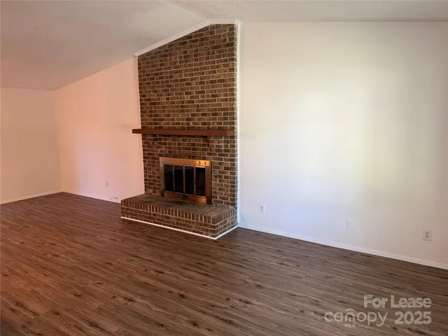 a view of fireplace with wooden floor