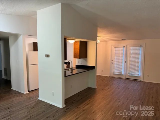 a kitchen with a refrigerator and a stove