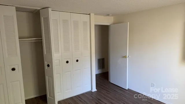 a view of closet area with wooden floor