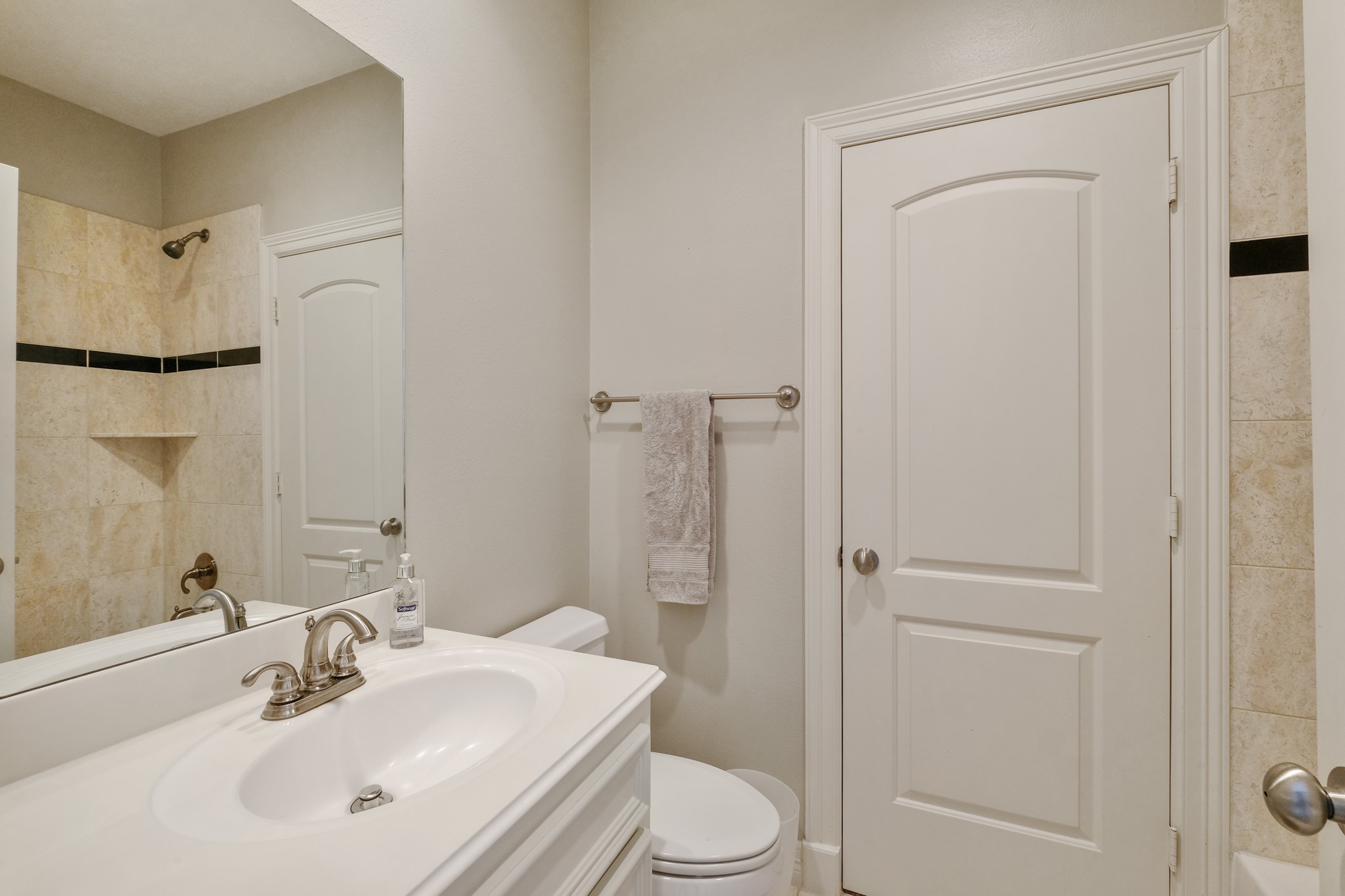 933 West 17th Street Houston, TX 77008 - Photo 14 of 19 Secondary bathroom featuring granite countertops, tile floors, a large mirror, and a shower/tub combo.
