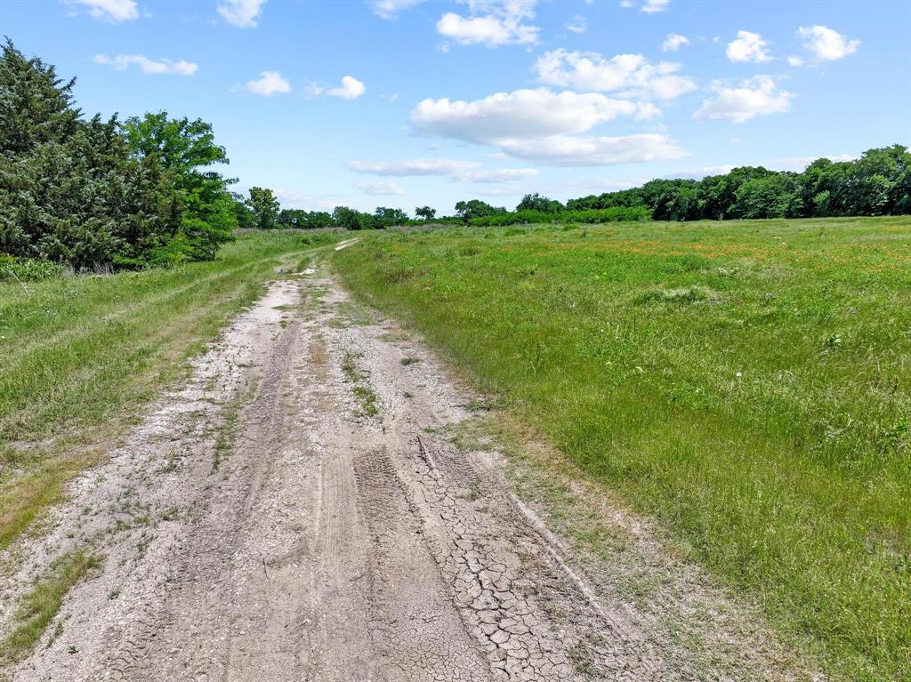 747 Vineyard Road Gunter, TX 75058 - Photo 22 of 32 a view of a lake with a big yard