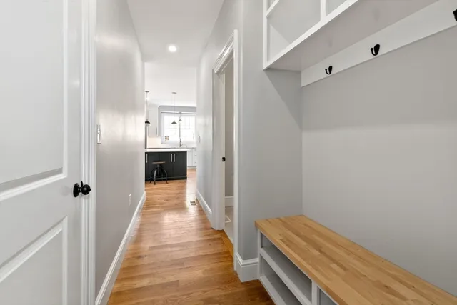 a view of a hallway with wooden floor and staircase