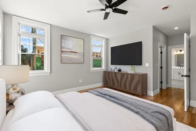 a bedroom with a large bed and a flat screen television