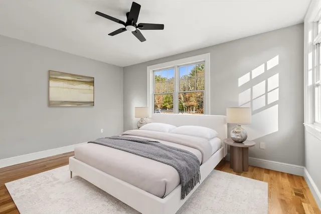 a bedroom with a large bed and a window