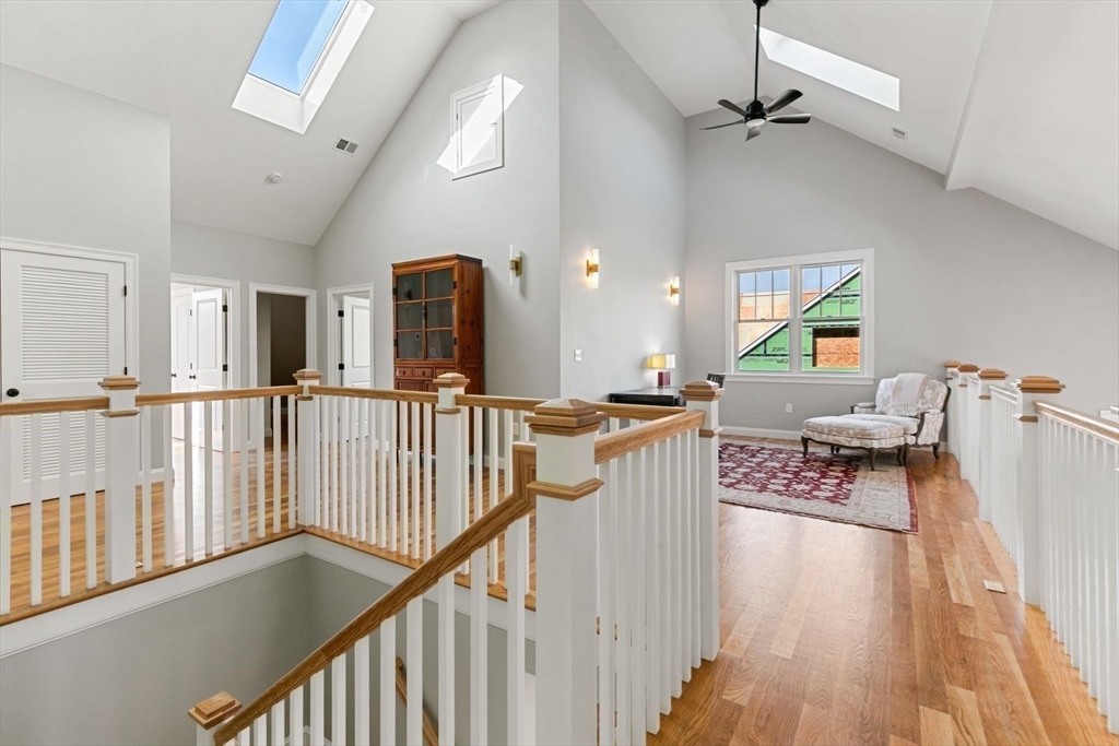 9 Adams Lane, Unit 9 Sherborn, MA 01770 - Photo 16 of 26 a view of a hallway with wooden floor and staircase