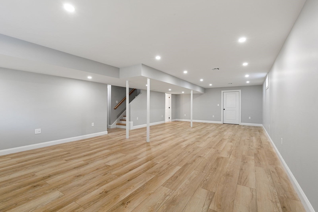 9 Adams Lane, Unit 9 Sherborn, MA 01770 - Photo 18 of 26 a view of empty room with wooden floor